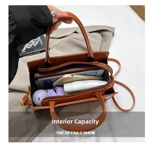 Interior view showing the large capacity of the brown croc-pattern crossbody bag