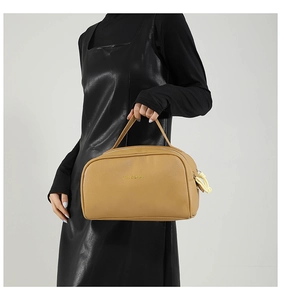 Detail of the litchi pattern leather handbag with modalu logo and braided rope puller