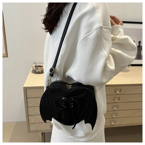 Gothic bat wing crossbody bag featuring a heart shape and lace-up ribbon details