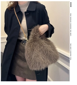 Detail of faux fox fur crossbody bag in brown with adjustable leather shoulder strap