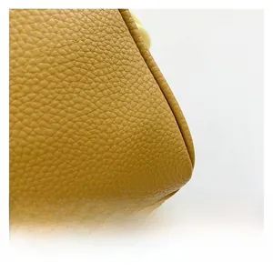 Detailed macro view showing the high-quality yellow pebbled leather texture and stitching