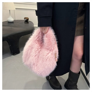 Detailed view of pink faux fox fur handbag with golden buckle and soft plush texture