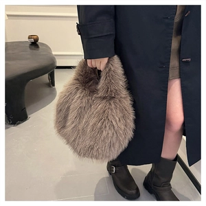 Detailed view of grey faux fur handbag showing long fluffy texture and soft handle