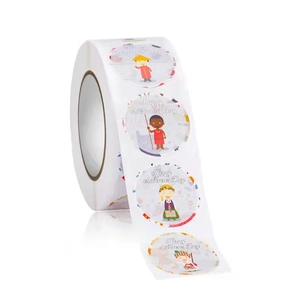 Macro side view of a roll of colorful round Happy Children's Day decorative stickers