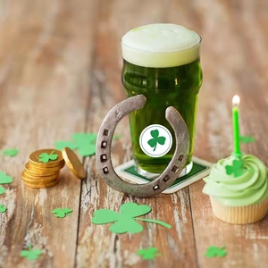 Lucky horseshoe with green shamrock for St. Patrick's Day with festive beer and gold coins