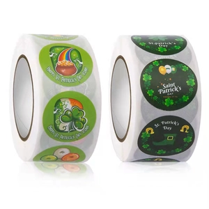 Roll of St. Patrick's Day round stickers with shamrocks and rainbows for Irish holiday