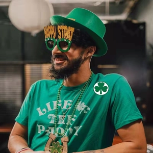 St. Patrick's Day party set featuring green hat, glasses, and graphic t-shirt outfit