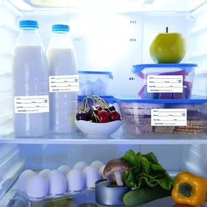 Food safety record labels on containers inside a refrigerator for kitchen organization
