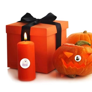 Halloween gift set featuring orange candle with Ghost time label and orange gift box with bow