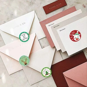 Christmas gift stickers with Santa and Reindeer designs on elegant envelopes
