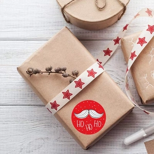 Festive red Christmas roll stickers with Santa beard and HO HO HO text on gift boxes