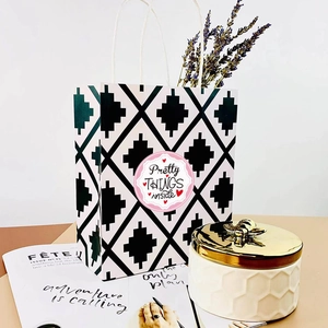 Christmas gift bag with geometric pattern and decorative 'Pretty THINGS' adhesive sticker