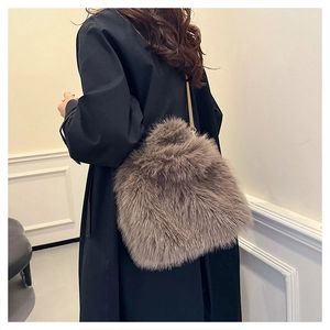 Detail of soft faux fox fur shoulder bag in taupe with long plush texture for winter