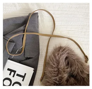 Detailed macro view of the fluffy brown faux fur bag with an adjustable faux leather strap