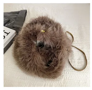Detail view of the light brown faux fur bag showing the gold buckle and soft plush texture