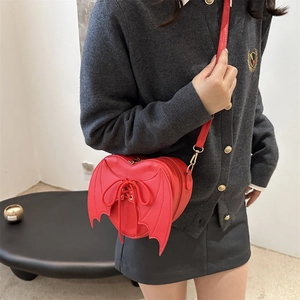 Red heart-shaped crossbody bag with gothic bat wings and lace-up ribbon details
