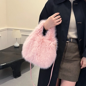 Vibrant pink faux fur bucket bag shown with cross-body strap for autumn winter fashion
