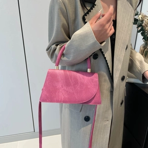 Minimalist fuchsia crossbody tote bag with matte finish and gold hardware handle