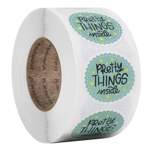 Roll of mint green scalloped oval stickers with Pretty Things Inside text and stars
