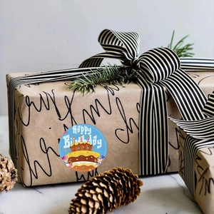 Blue round Happy Birthday sticker with cake illustration on a kraft gift box