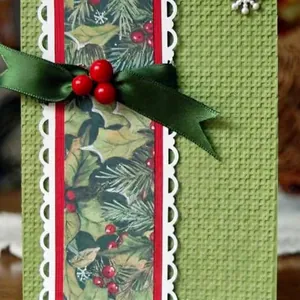 Christmas themed handmade card with green grid texture and red berry ribbon decoration