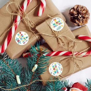 Festive round Christmas stickers featuring Santa and holiday motifs on gift packaging