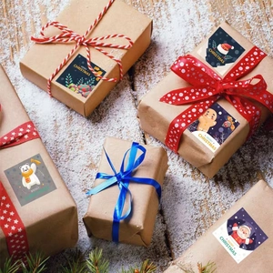Merry Christmas kraft paper stickers with Santa and reindeer on a gift box background
