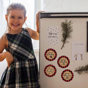 Close-up of red buffalo plaid Merry Christmas stickers on a fridge with a smiling girl