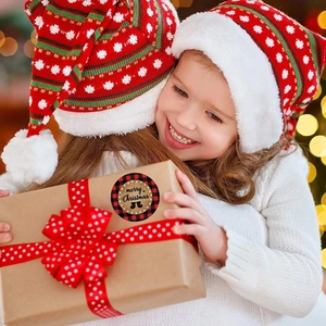 Merry Christmas round stickers with red buffalo plaid border on a kraft gift box
