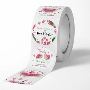 Roll of watermelon themed thank you stickers with vibrant watercolor fruit patterns