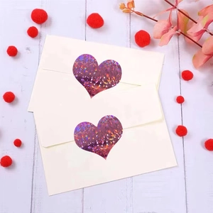 Pink holographic heart stickers with laser texture on white envelopes for Valentine's Day
