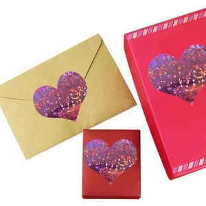 Pink holographic heart stickers on gift boxes and brown envelopes for Valentine's Day decor