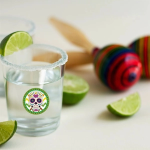 Mexican sugar skull shot glass with lime and maracas for a vibrant summer party