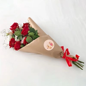 Close-up of red and white roses bouquet with I Love You bear sticker and red silk ribbon