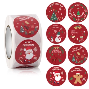 Detail of red Merry Christmas stickers roll with Santa, snowman, and reindeer patterns