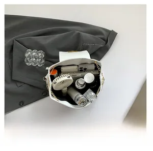 Overhead view showing large interior capacity of the white leather shoulder bag