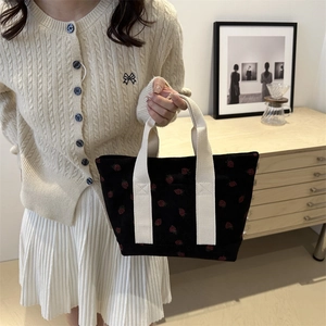 Black corduroy tote bag with red strawberry pattern and off-white canvas handles