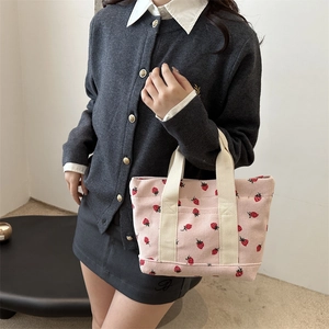 Minimalist pink corduroy tote bag with strawberry print and ivory canvas handles