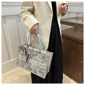 Detail of silver floral tote bag with silk scarf handle and Fashion Bag text detail