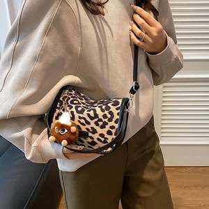 Retro leopard print crossbody pillow bag with black trim and plush doll charm