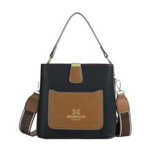 Minimalist bucket bag in black pebble leather with brown pocket and wide woven strap