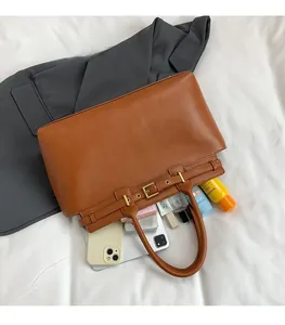 Detail view of large brown tote bag showing ample internal storage for cosmetics