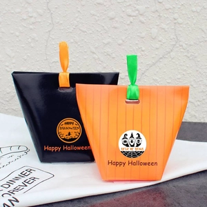 Halloween gift bags with Happy Halloween text and orange ribbons in black and stripes