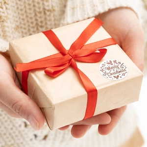 Rose gold Christmas stickers on white background for gift boxes with festive foliage and text