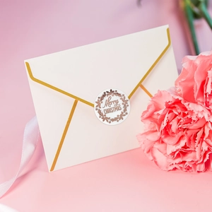 Merry Christmas rose gold foil stickers on white envelopes with festive floral background