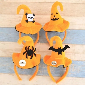 Detail of four orange Halloween headbands with wizard hats and various spooky decals