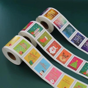 Three rolls of colorful Merry Christmas adhesive stickers with Santa and reindeer motifs