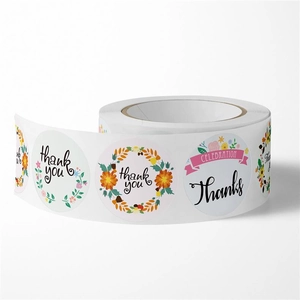 Detailed view of roll-packed thank you stickers with four colorful floral designs