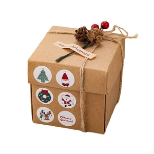 Kraft paper Christmas gift box with hemp rope, pine cones and festive round stickers