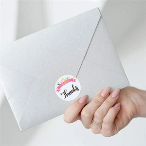 Floral Thank You sticker with Celebration ribbon used to seal a silver envelope